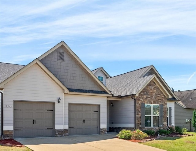 2711 Tara Ct, Opelika, AL 36804 - view of front of property featuring stone siding, a garage, driveway, and roof with shingles