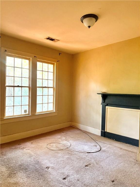 unfurnished living room featuring carpet