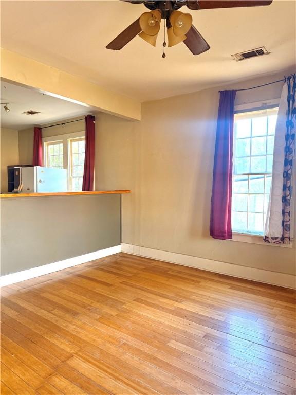 spare room with ceiling fan and light hardwood / wood-style flooring