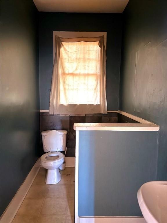 bathroom with tile patterned flooring and toilet