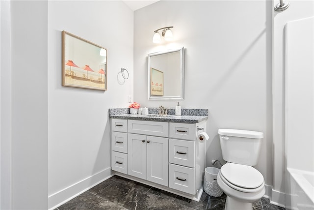 617 Cameron Ct, Auburn, AL 36830 - full bathroom featuring baseboards, vanity, toilet, marble look tile flooring, and a tub to relax in