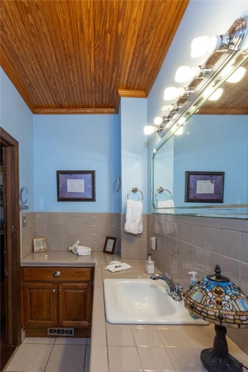 bathroom with ornamental molding, wooden ceiling, and a sink