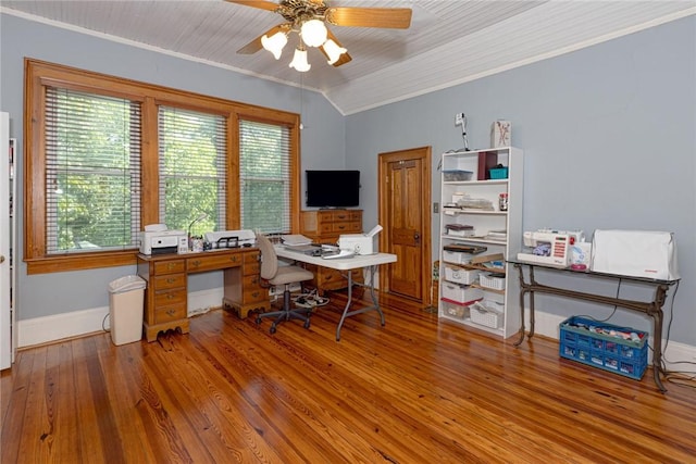 office area featuring baseboards, lofted ceiling, ornamental molding, wood finished floors, and a ceiling fan