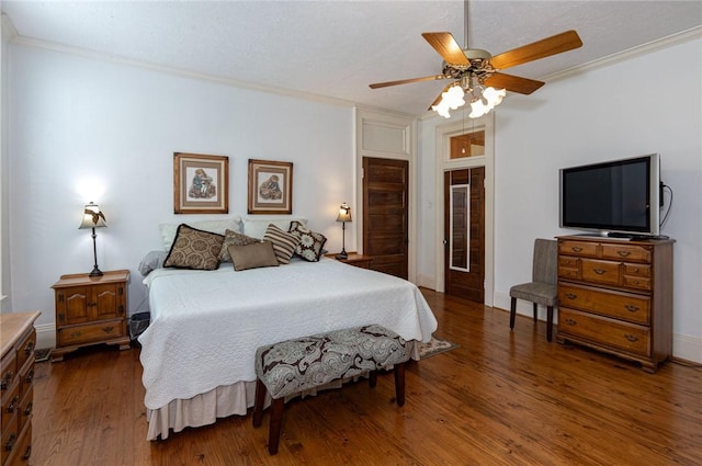 bedroom featuring ornamental molding, baseboards, ceiling fan, and wood finished floors