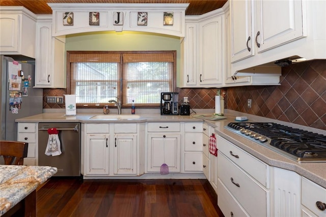 kitchen featuring dark wood-type flooring, a sink, stainless steel appliances, white cabinets, and light countertops