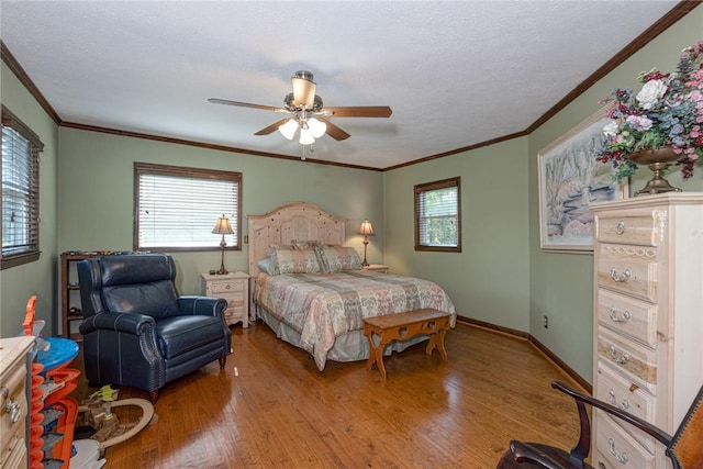 bedroom with a ceiling fan, wood finished floors, baseboards, and ornamental molding