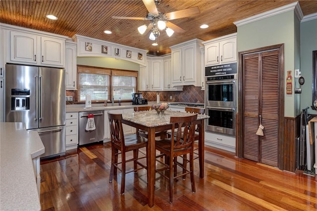 kitchen featuring crown molding, white cabinets, wood ceiling, and stainless steel appliances