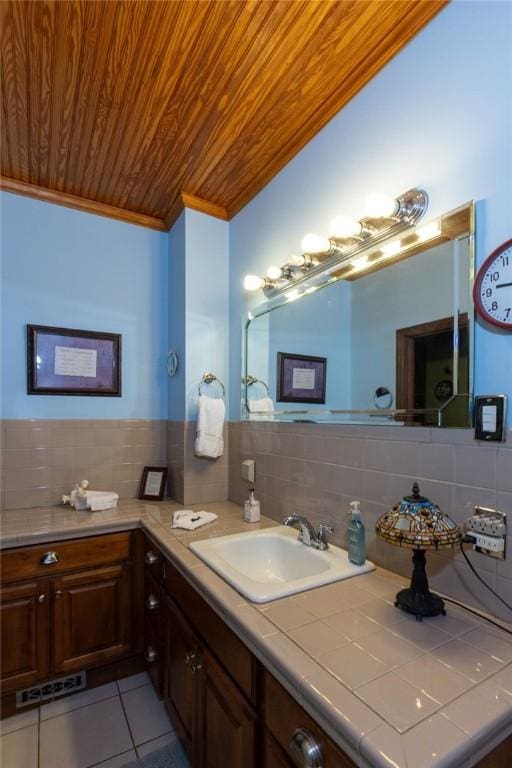 bathroom with ornamental molding, backsplash, tile patterned flooring, wood ceiling, and vanity