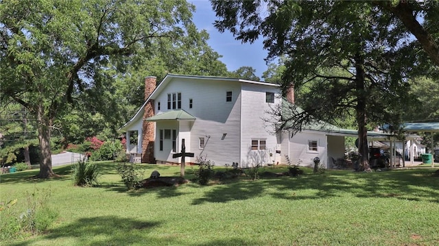 view of front of property with a front lawn and a chimney