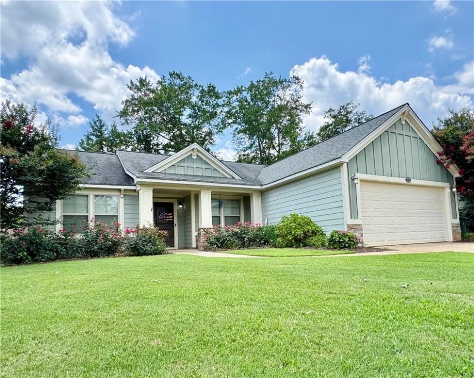 2225 Red Tail Ln, Auburn, AL 36879 - craftsman inspired home featuring an attached garage, board and batten siding, a front yard, driveway, and roof with shingles