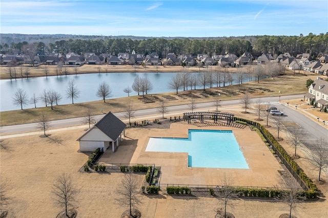 view of swimming pool with a patio area and a water view