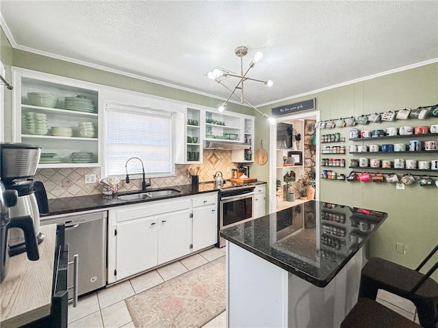 kitchen featuring light tile patterned floors, stainless steel appliances, a sink, white cabinetry, and open shelves