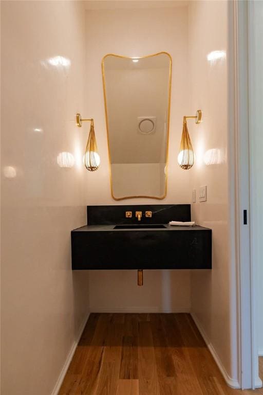 bathroom with wood-type flooring and sink