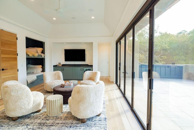 sunroom featuring a wealth of natural light, ceiling fan, and vaulted ceiling