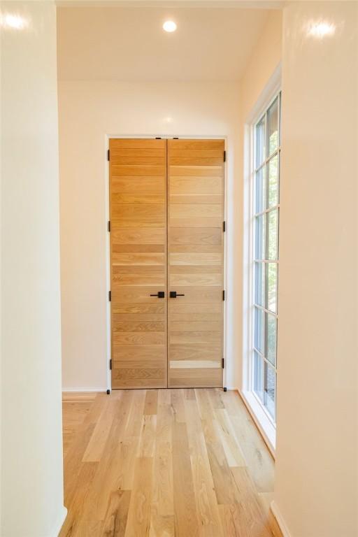 hallway with light hardwood / wood-style flooring