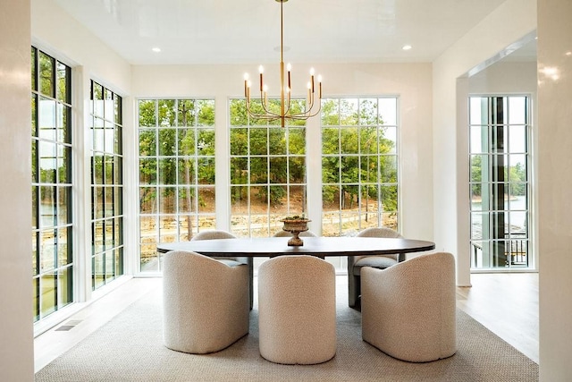 sunroom featuring a chandelier