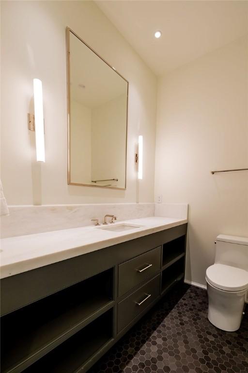 bathroom featuring vanity and toilet