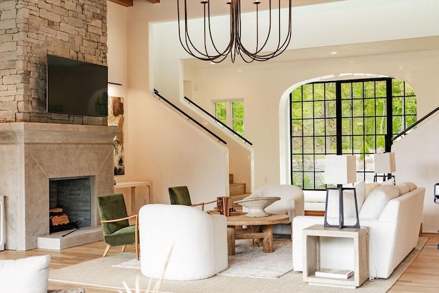 interior space featuring a fireplace, light hardwood / wood-style floors, and an inviting chandelier