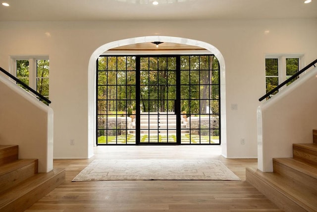 foyer with ceiling fan and light wood-type flooring