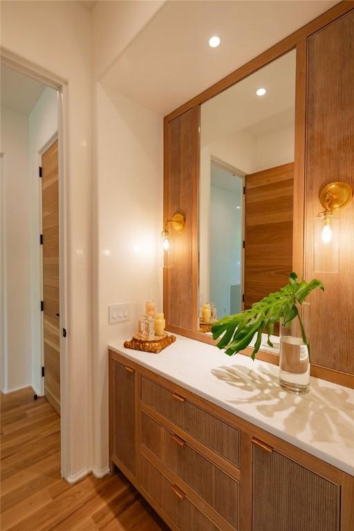 bathroom with vanity and wood-type flooring