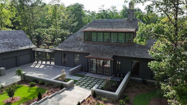 rear view of property featuring a garage