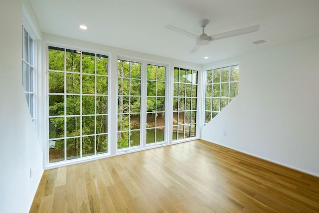 unfurnished sunroom featuring ceiling fan