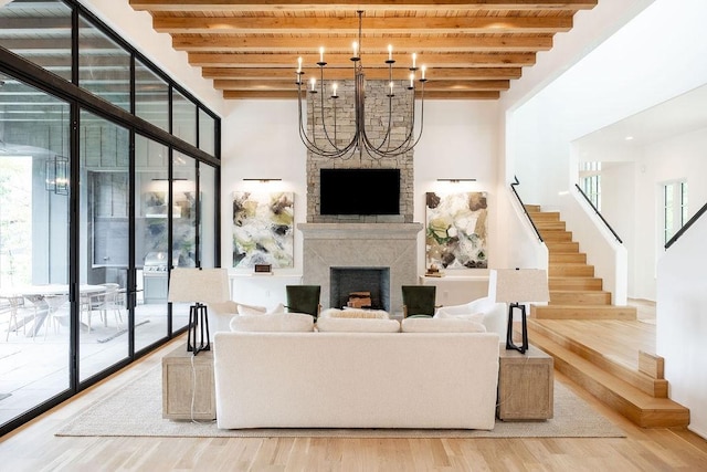 living room featuring a high end fireplace, beam ceiling, and hardwood / wood-style flooring