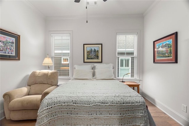 bedroom featuring ceiling fan, hardwood / wood-style floors, and ornamental molding