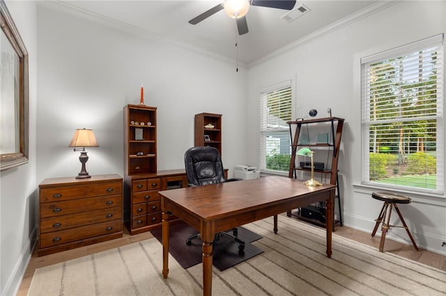 home office with a healthy amount of sunlight, light wood-type flooring, ceiling fan, and crown molding