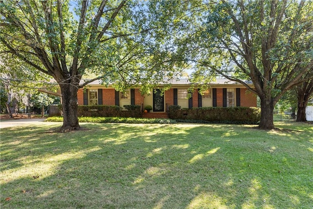 ranch-style home featuring a front yard