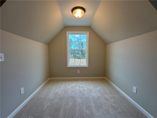 bonus room featuring light carpet and lofted ceiling