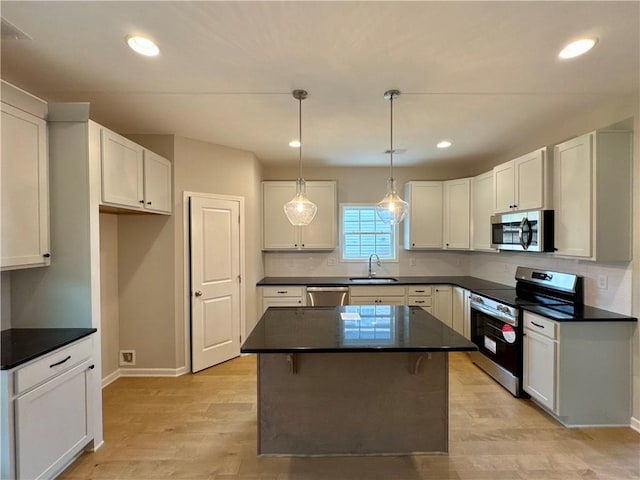 kitchen with a center island, stainless steel appliances, and white cabinetry