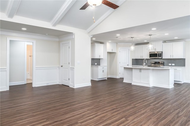 unfurnished living room featuring dark wood-type flooring, ceiling fan, crown molding, and beam ceiling