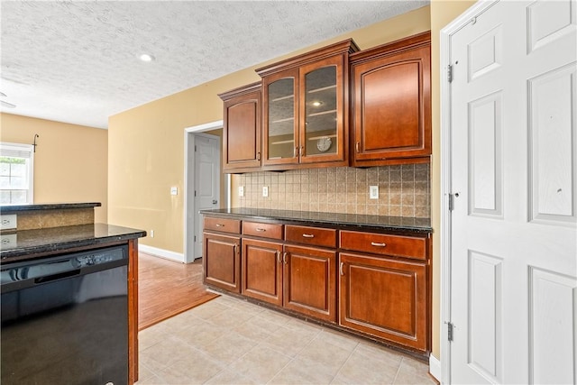 1817 Roanoke Ln, Auburn, AL 36830 - kitchen featuring dishwasher, backsplash, a textured ceiling, glass insert cabinets, and brown cabinets