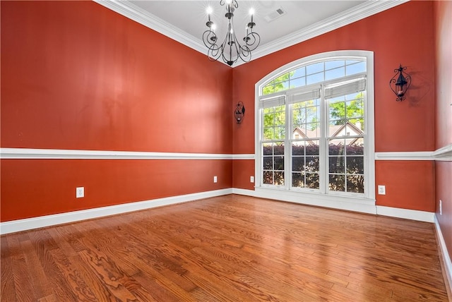 1817 Roanoke Ln, Auburn, AL 36830 - empty room featuring a chandelier, wood finished floors, and ornamental molding