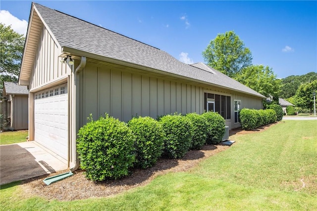 1630 Academy Dr Unit 402, Auburn, AL 36830 - view of side of home featuring a shingled roof, a yard, board and batten siding, and an attached garage