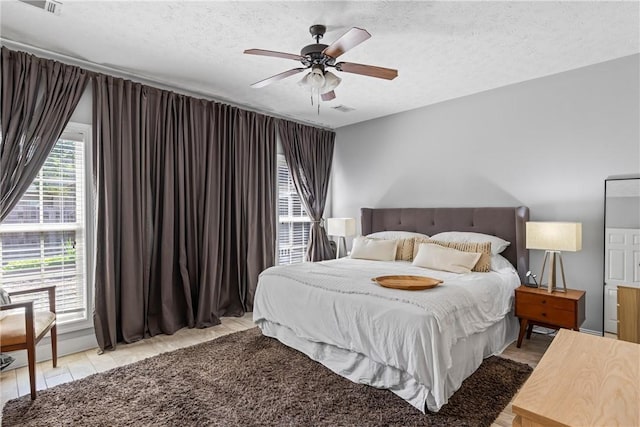 1630 Academy Dr Unit 402, Auburn, AL 36830 - bedroom with a textured ceiling and a ceiling fan