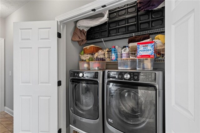 1630 Academy Dr Unit 402, Auburn, AL 36830 - laundry area featuring washing machine and clothes dryer, tile patterned floors, and a textured ceiling