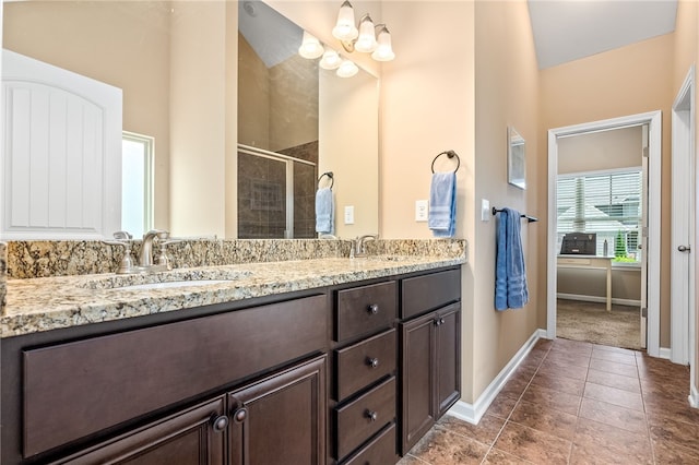 704 Lori Ln, Opelika, AL 36804 - bathroom with baseboards, a shower stall, double vanity, and tile patterned flooring