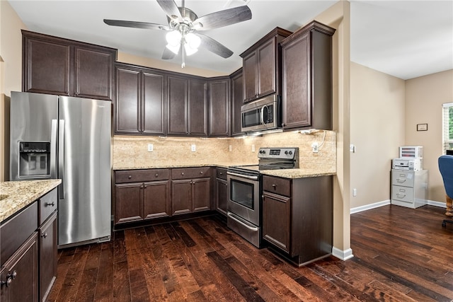 704 Lori Ln, Opelika, AL 36804 - kitchen featuring stainless steel appliances, dark wood-style floors, dark brown cabinets, decorative backsplash, and light stone counters