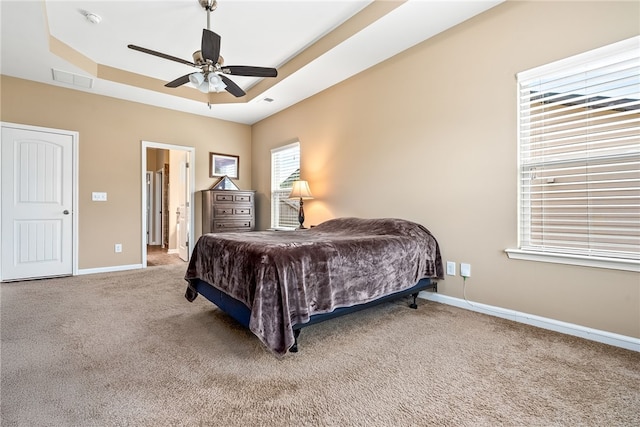 704 Lori Ln, Opelika, AL 36804 - carpeted bedroom featuring a raised ceiling, baseboards, and a ceiling fan