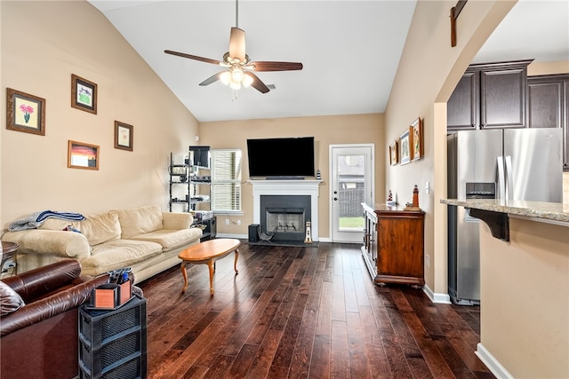 704 Lori Ln, Opelika, AL 36804 - living area featuring vaulted ceiling, ceiling fan, dark wood-style flooring, a fireplace, and baseboards
