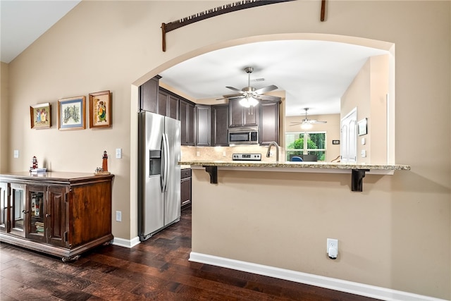 704 Lori Ln, Opelika, AL 36804 - kitchen featuring stainless steel appliances, a kitchen bar, dark wood finished floors, and a ceiling fan