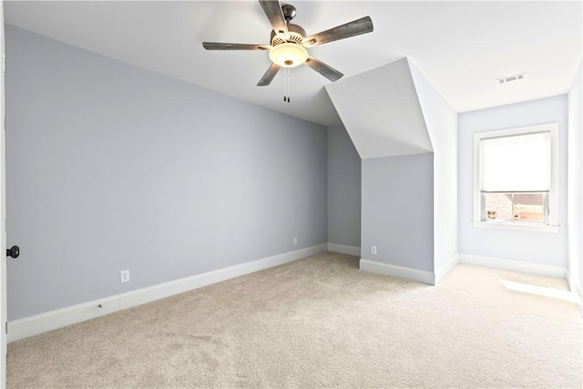 bonus room with visible vents, ceiling fan, light carpet, and baseboards