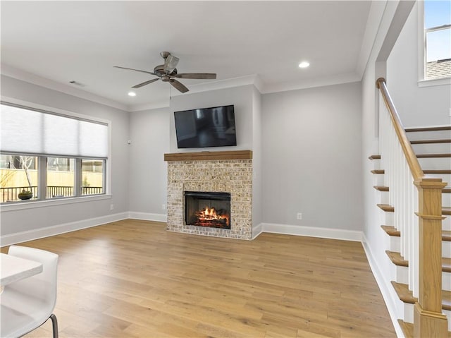 unfurnished living room featuring crown molding, light wood finished floors, visible vents, ceiling fan, and baseboards