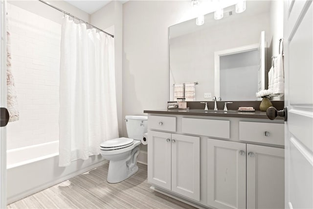 bathroom featuring toilet, shower / bath combination with curtain, and vanity