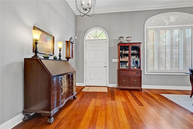 1939 Windway Rd, Auburn, AL 36830 - entryway with wood finished floors, a chandelier, baseboards, and crown molding