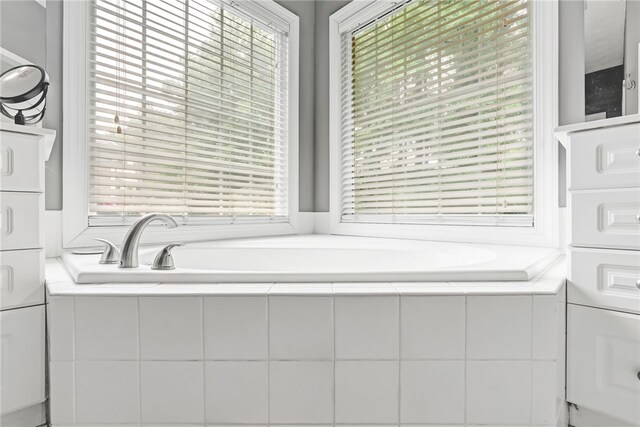 1939 Windway Rd, Auburn, AL 36830 - bathroom featuring plenty of natural light, a bath, and stacked washer / dryer