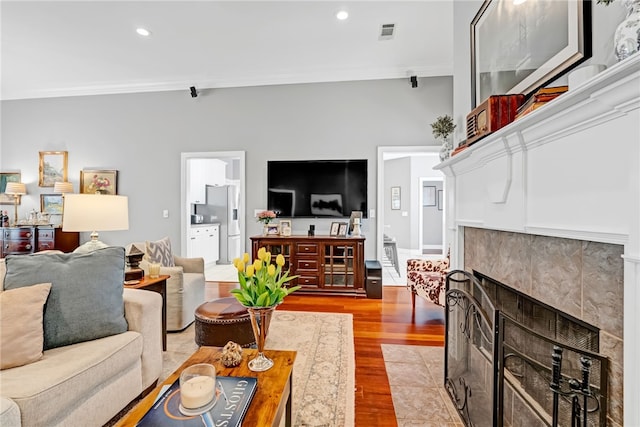 1939 Windway Rd, Auburn, AL 36830 - living area with wood finished floors, recessed lighting, ornamental molding, and a tiled fireplace