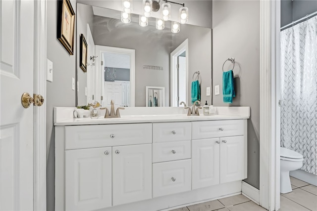 1939 Windway Rd, Auburn, AL 36830 - full bathroom with toilet, double vanity, tile patterned floors, a shower with shower curtain, and baseboards